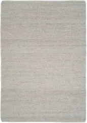 Matný vlnený koberec v guľôčkovom dizajne a striebornej farbe.
