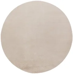 Krémovo béžový kruhový koberec z plyšového materiálu.