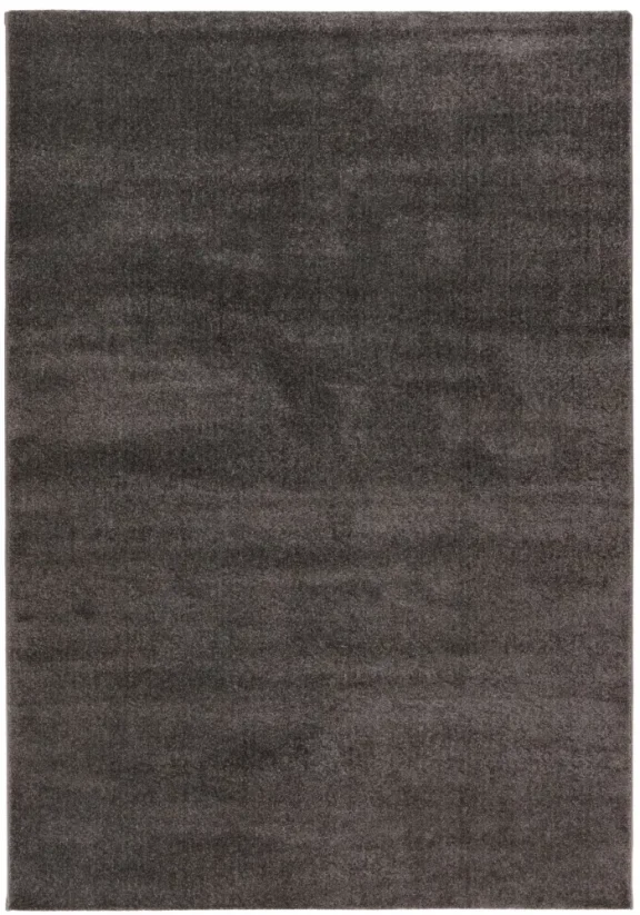 Jednofarebný sivý koberec, z jednej strany je o niečo svetlejší a z druhej strany o niečo tmavší.